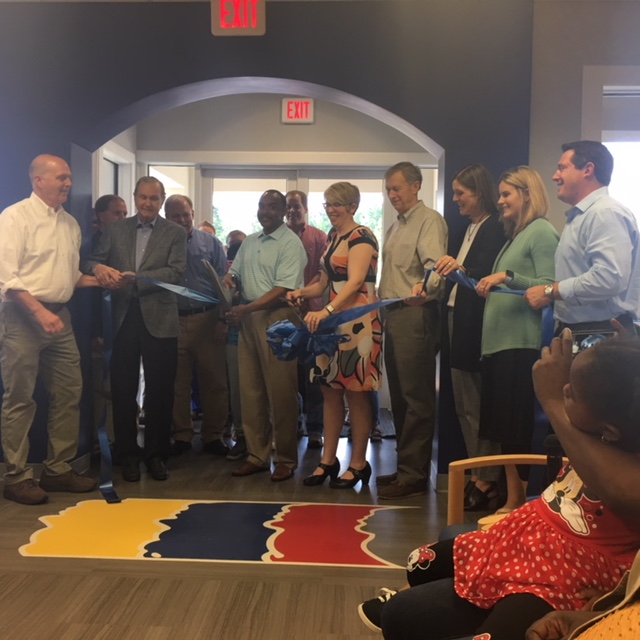 RIBBON CUTTING - Dr. Kenneth Brown, center, is surrounded by board members as he cuts the ribbon Thursday, April 26 officially opening the permanent home of Ozark Pediatrics.RIBBON CUTTING - Dr. Kenneth Brown, center, is surrounded by board members as he cuts the ribbon Thursday, April 26 officially opening the permanent home of Ozark Pediatrics.