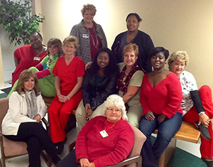 Home Health Services Staff smiling for a group picture. There is eleven females