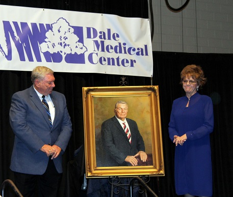 Mr. and Mrs. Larry Ezell posing with his portrait to be displayed in hospital lobby.Mr. and Mrs. Larry Ezell posing with his portrait to be displayed in hospital lobby.